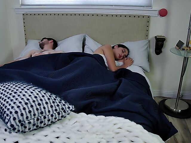 Brunette nurse Luz masturbating next to a sleeping guy in his bed