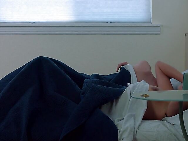 Brunette nurse Luz masturbating next to a sleeping guy in his bed