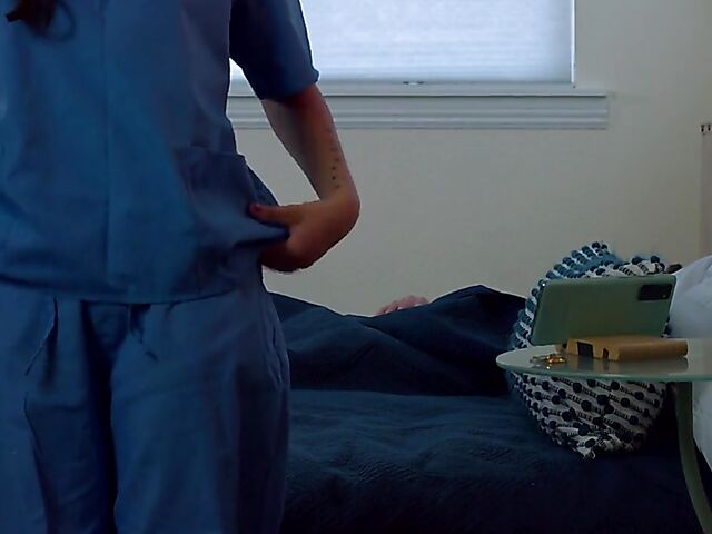 Brunette nurse Luz masturbating next to a sleeping guy in his bed