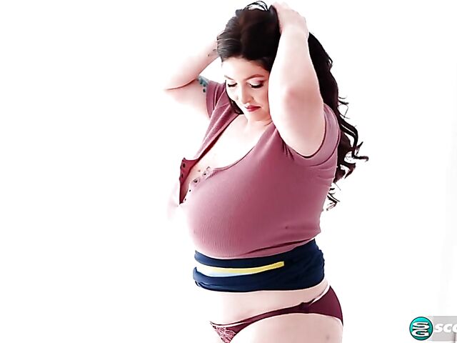 Busty chubby woman Demora Avarice changing clothes and showing off her heavy hangers