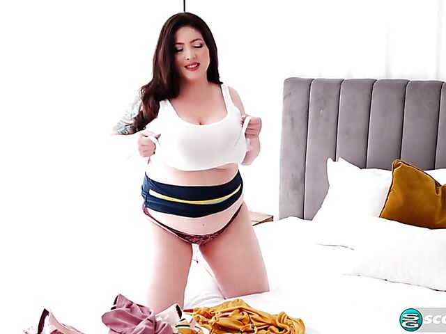 Busty chubby woman Demora Avarice changing clothes and showing off her heavy hangers