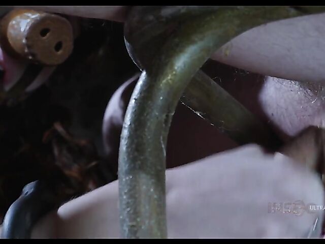 Pale skin girl Brooke Johnson in metal bondage