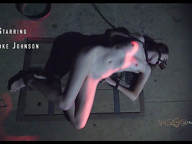 Pale skin girl Brooke Johnson in metal bondage
