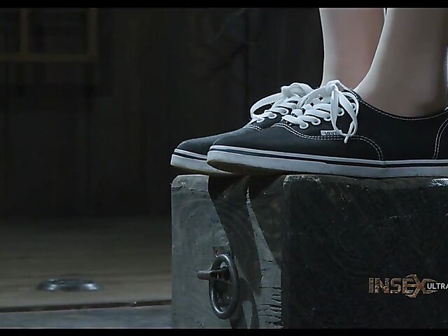 Pale skin girl Brooke Johnson in metal bondage