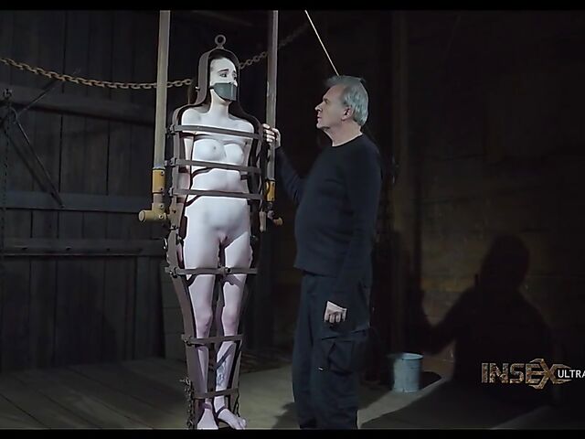 Pale skin girl Brooke Johnson in metal bondage