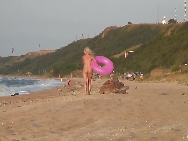 Nudist teen Agnes poses on the beach and takes a dip