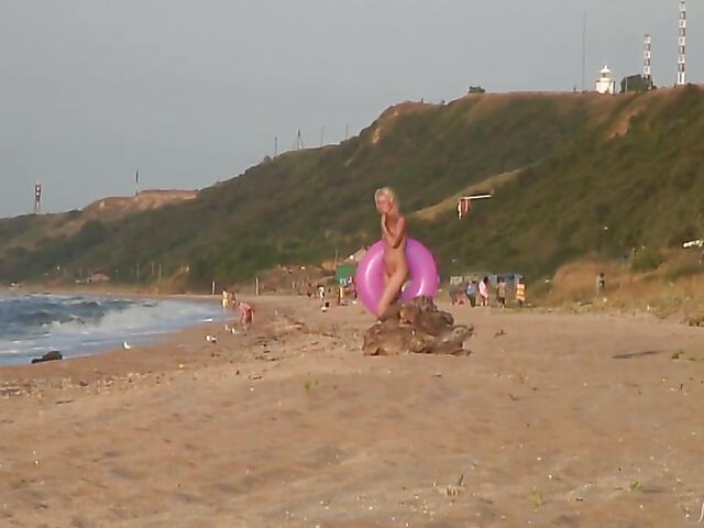 Nudist teen Agnes poses on the beach and takes a dip