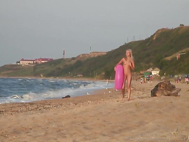 Nudist teen Agnes poses on the beach and takes a dip