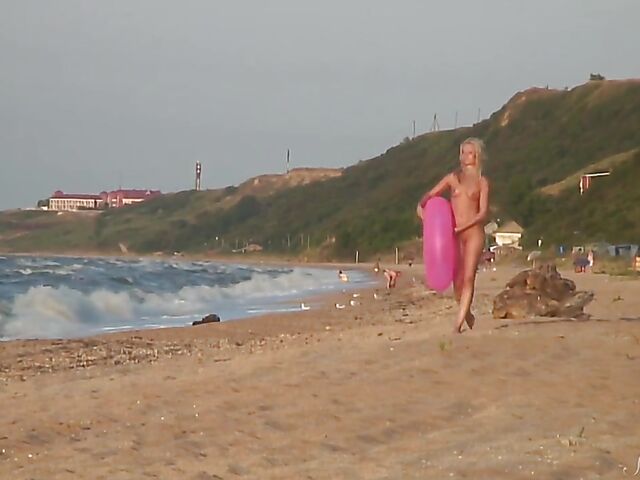 Nudist teen Agnes poses on the beach and takes a dip