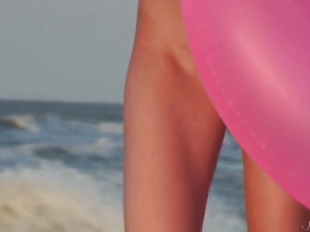 Nudist teen Agnes poses on the beach and takes a dip