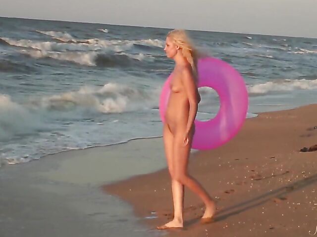 Nudist teen Agnes poses on the beach and takes a dip