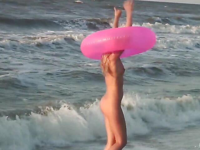 Nudist teen Agnes poses on the beach and takes a dip