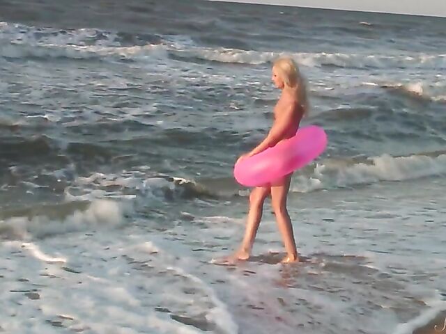 Nudist teen Agnes poses on the beach and takes a dip