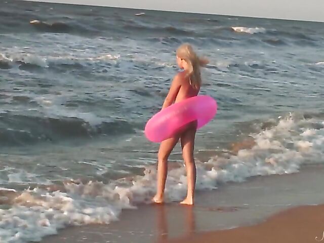 Nudist teen Agnes poses on the beach and takes a dip