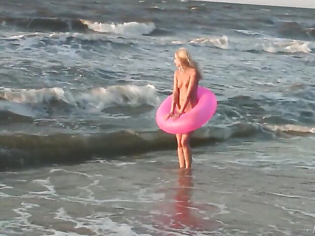 Nudist teen Agnes poses on the beach and takes a dip