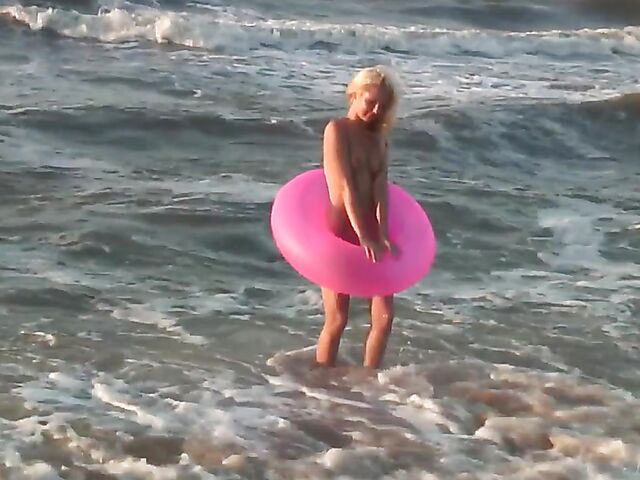 Nudist teen Agnes poses on the beach and takes a dip