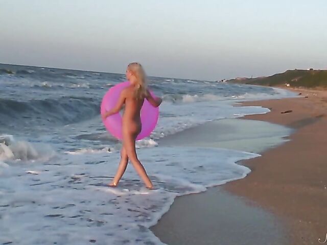 Nudist teen Agnes poses on the beach and takes a dip