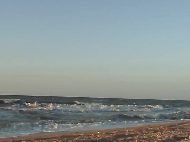 Nudist teen Agnes poses on the beach and takes a dip