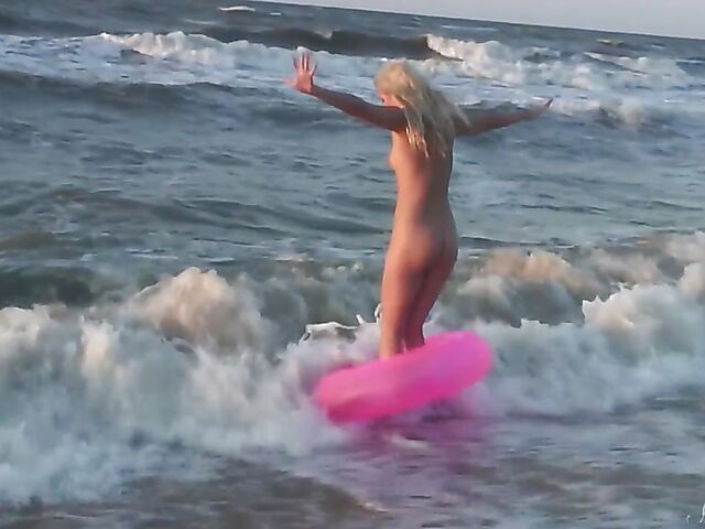 Nudist teen Agnes poses on the beach and takes a dip