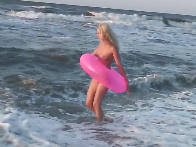 Nudist teen Agnes poses on the beach and takes a dip