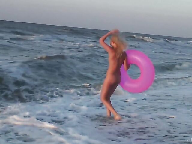 Nudist teen Agnes poses on the beach and takes a dip