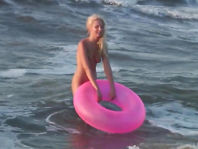 Nudist teen Agnes poses on the beach and takes a dip