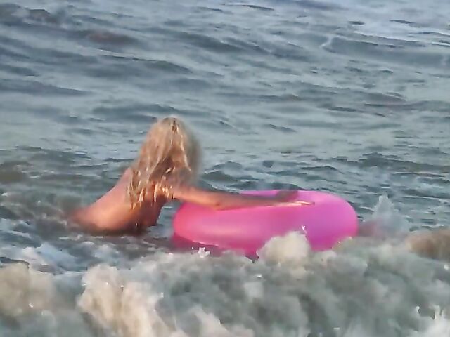 Nudist teen Agnes poses on the beach and takes a dip