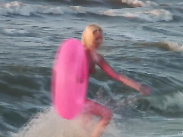 Nudist teen Agnes poses on the beach and takes a dip