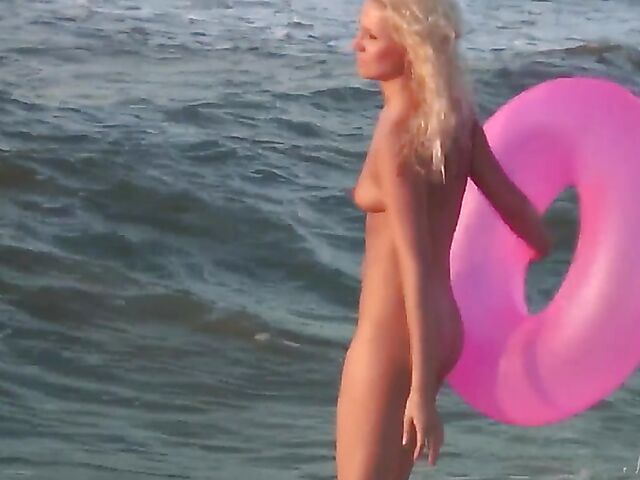 Nudist teen Agnes poses on the beach and takes a dip