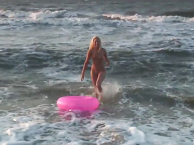 Nudist teen Agnes poses on the beach and takes a dip