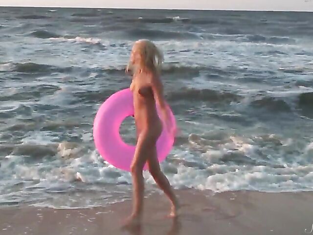 Nudist teen Agnes poses on the beach and takes a dip