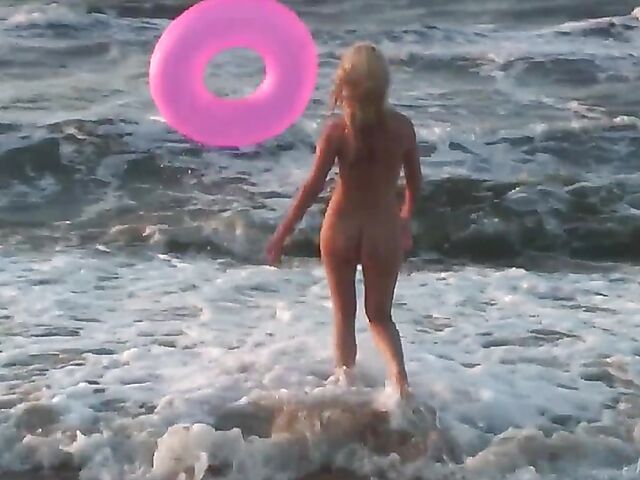 Nudist teen Agnes poses on the beach and takes a dip