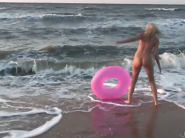 Nudist teen Agnes poses on the beach and takes a dip