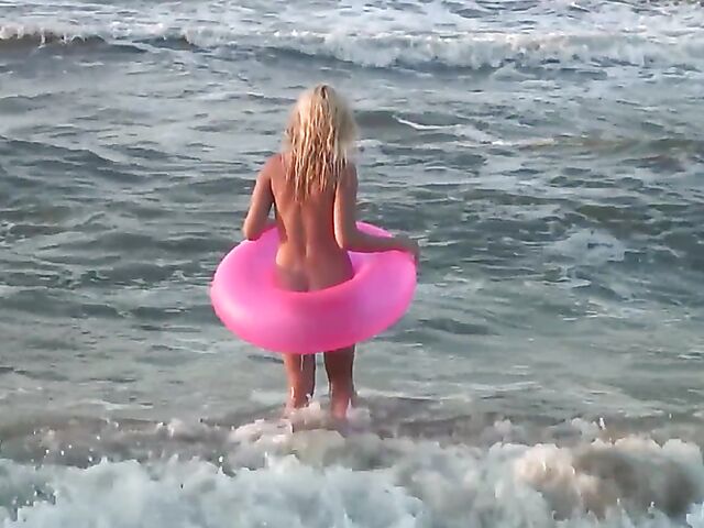 Nudist teen Agnes poses on the beach and takes a dip