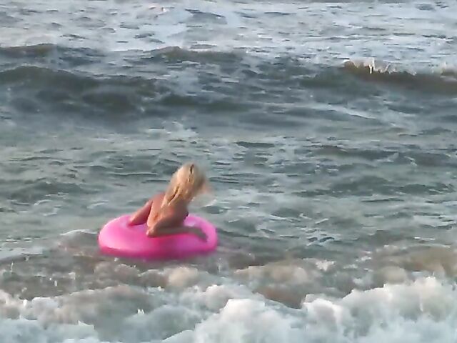 Nudist teen Agnes poses on the beach and takes a dip