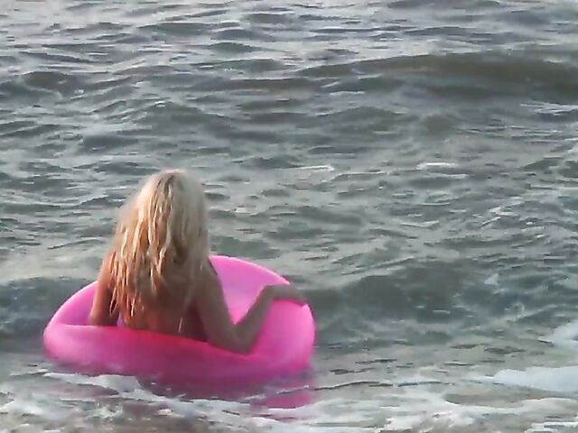 Nudist teen Agnes poses on the beach and takes a dip