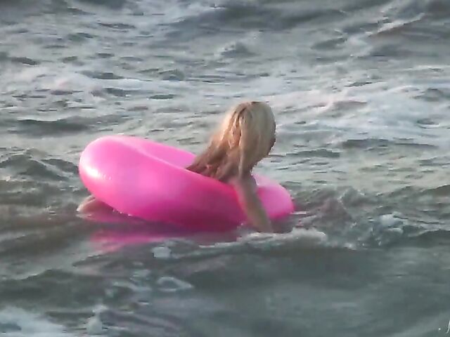 Nudist teen Agnes poses on the beach and takes a dip