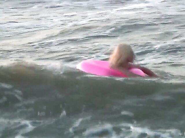 Nudist teen Agnes poses on the beach and takes a dip