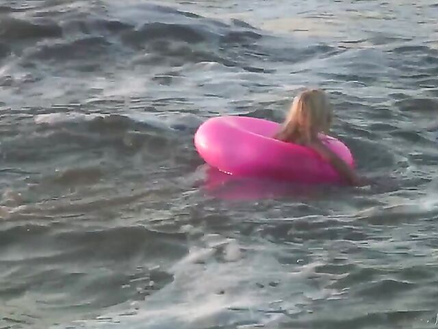 Nudist teen Agnes poses on the beach and takes a dip