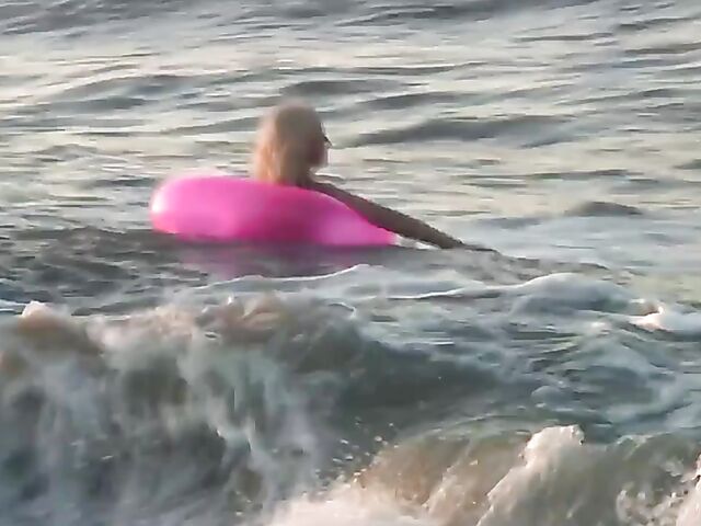 Nudist teen Agnes poses on the beach and takes a dip