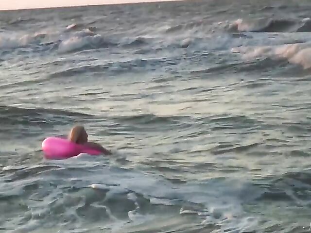 Nudist teen Agnes poses on the beach and takes a dip