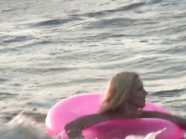 Nudist teen Agnes poses on the beach and takes a dip