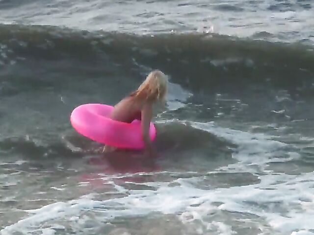 Nudist teen Agnes poses on the beach and takes a dip