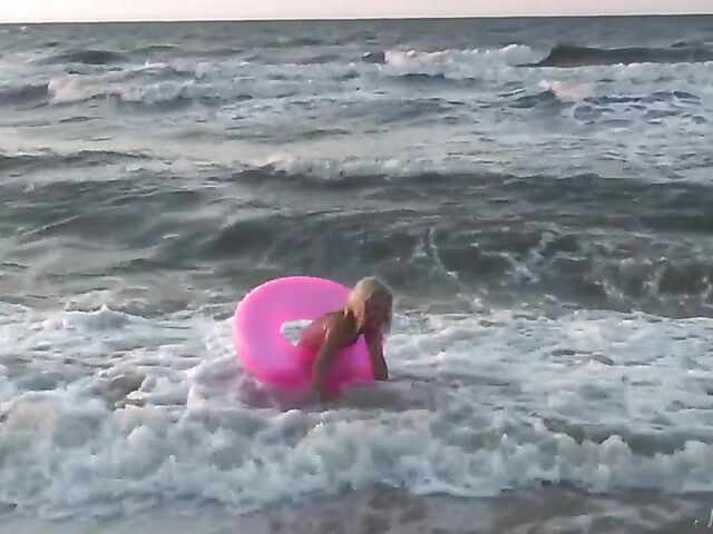 Nudist teen Agnes poses on the beach and takes a dip