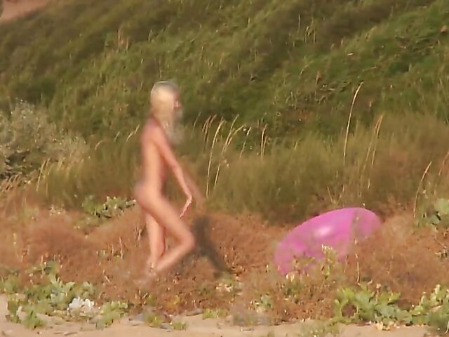 Nudist teen Agnes poses on the beach and takes a dip