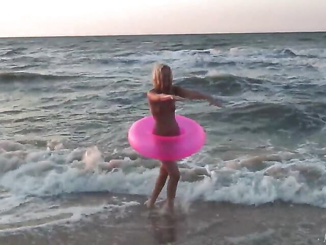 Nudist teen Agnes poses on the beach and takes a dip