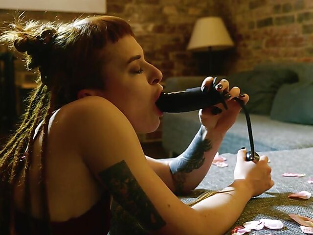 Tattooed redhead Bryla loves her black inflatable dildo