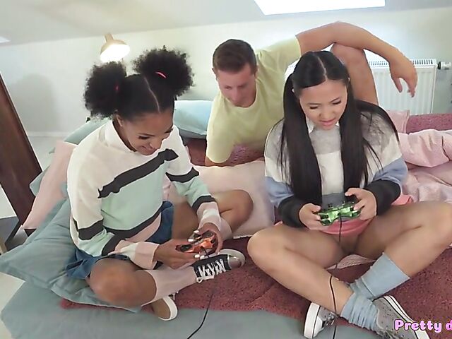 Gamer girls May Thai and Tina Fire masturbate and fuck a cock in interracial FFM threesome