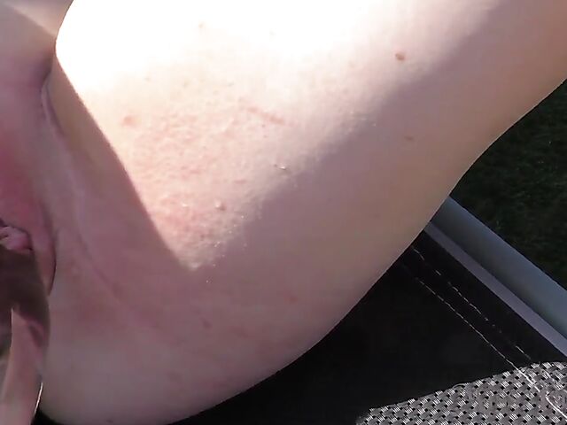 Blonde with glasses Mia shows off her nude body in the hot tub and takes her glass dildo