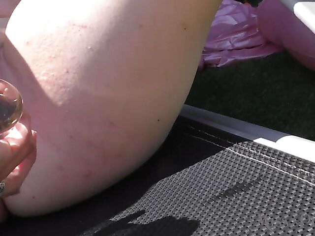 Blonde with glasses Mia shows off her nude body in the hot tub and takes her glass dildo